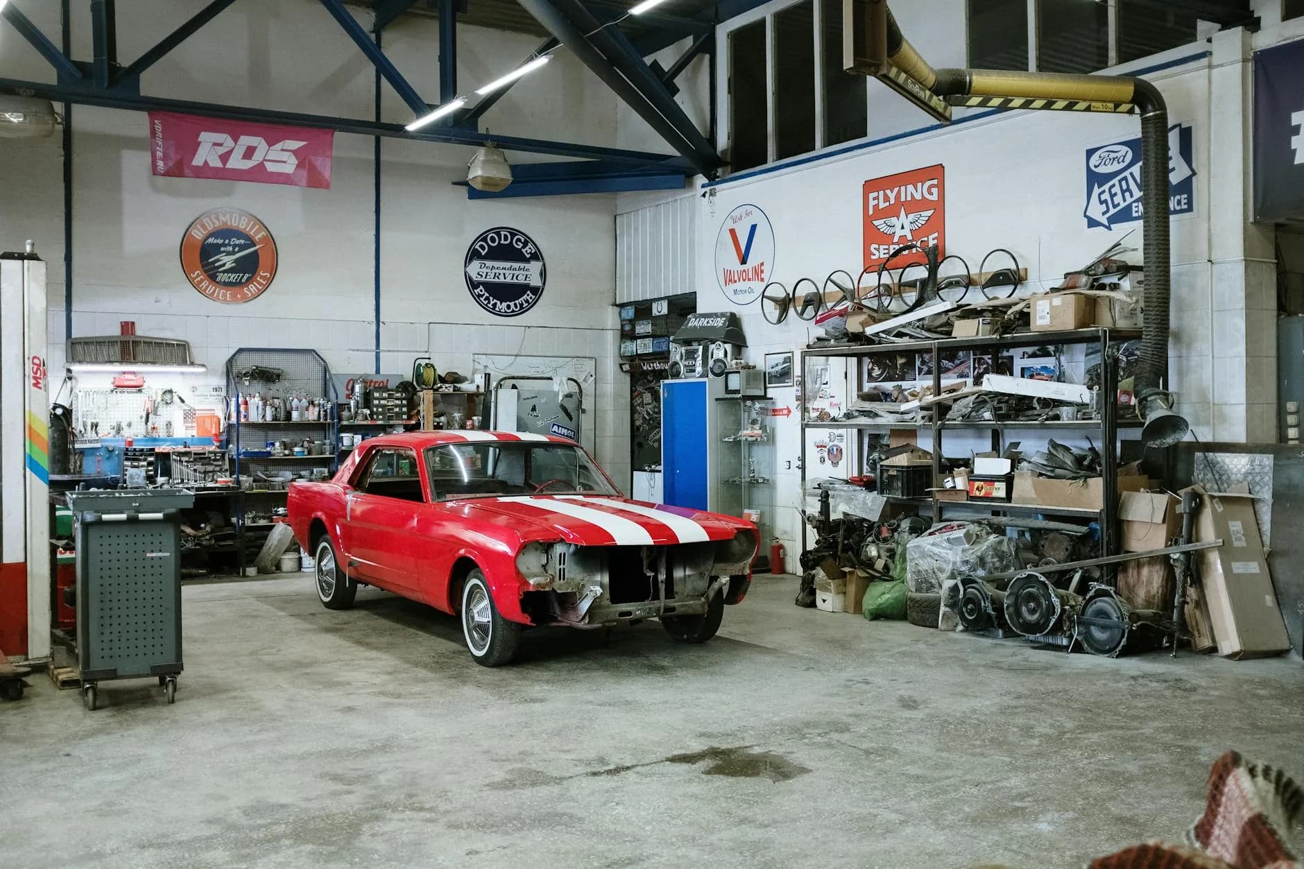 Auto repair workshop with mechanics working on vehicles