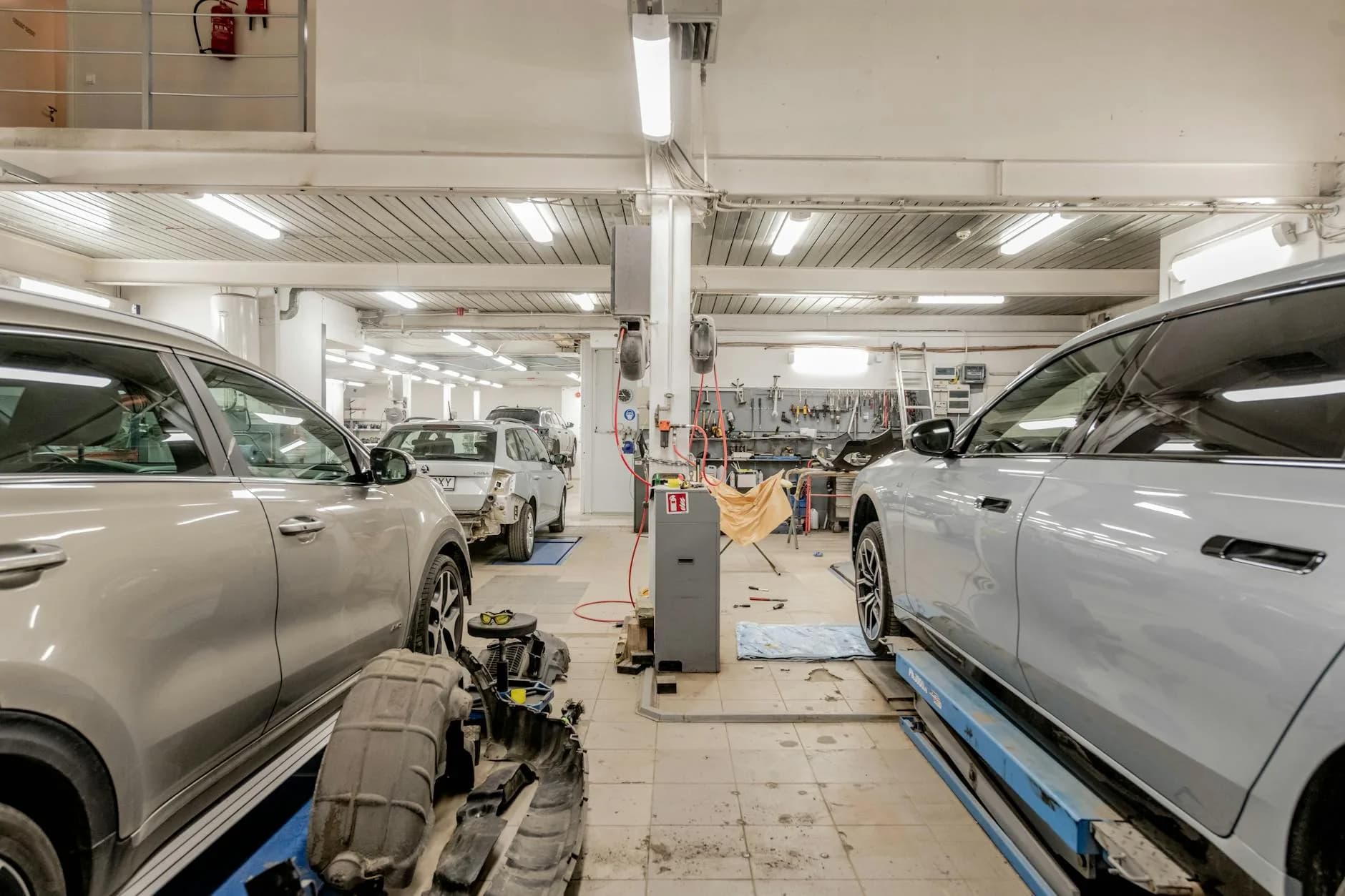 Well-equipped garage workshop with vehicles being serviced