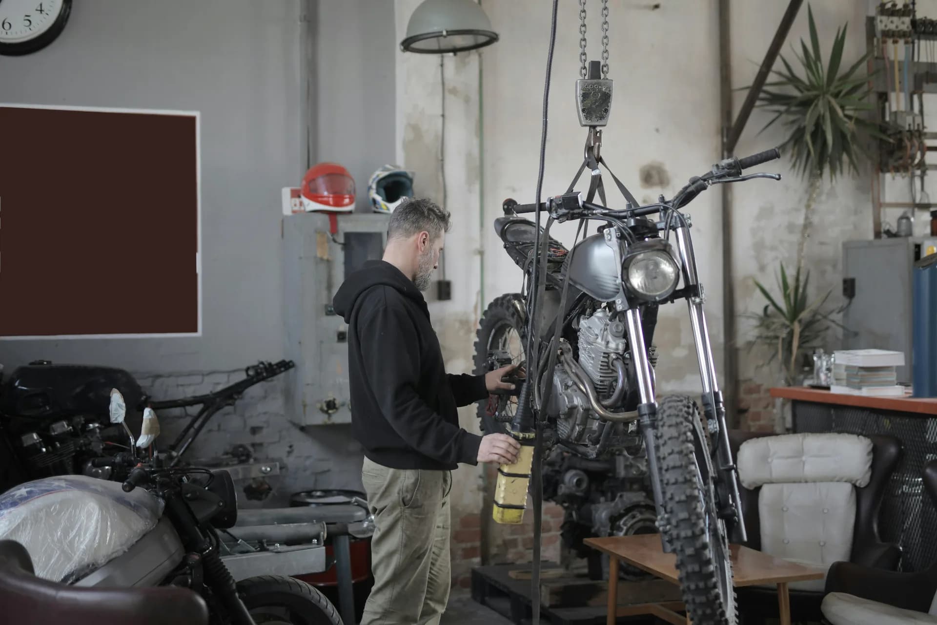 Mechanic fitting a tyre using a tyre machine at a garage