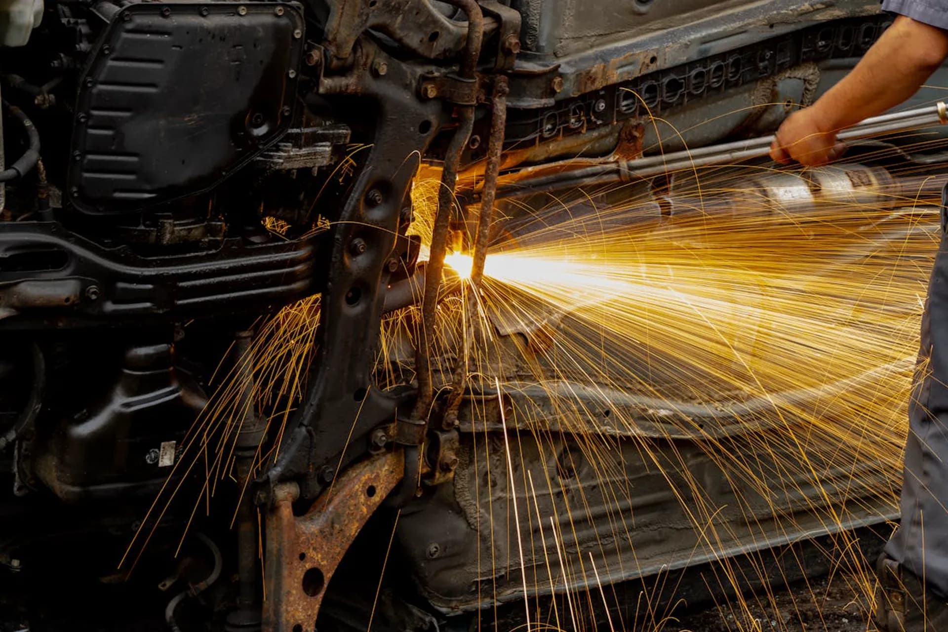 Sparks flying during welding repair underneath a vehicle