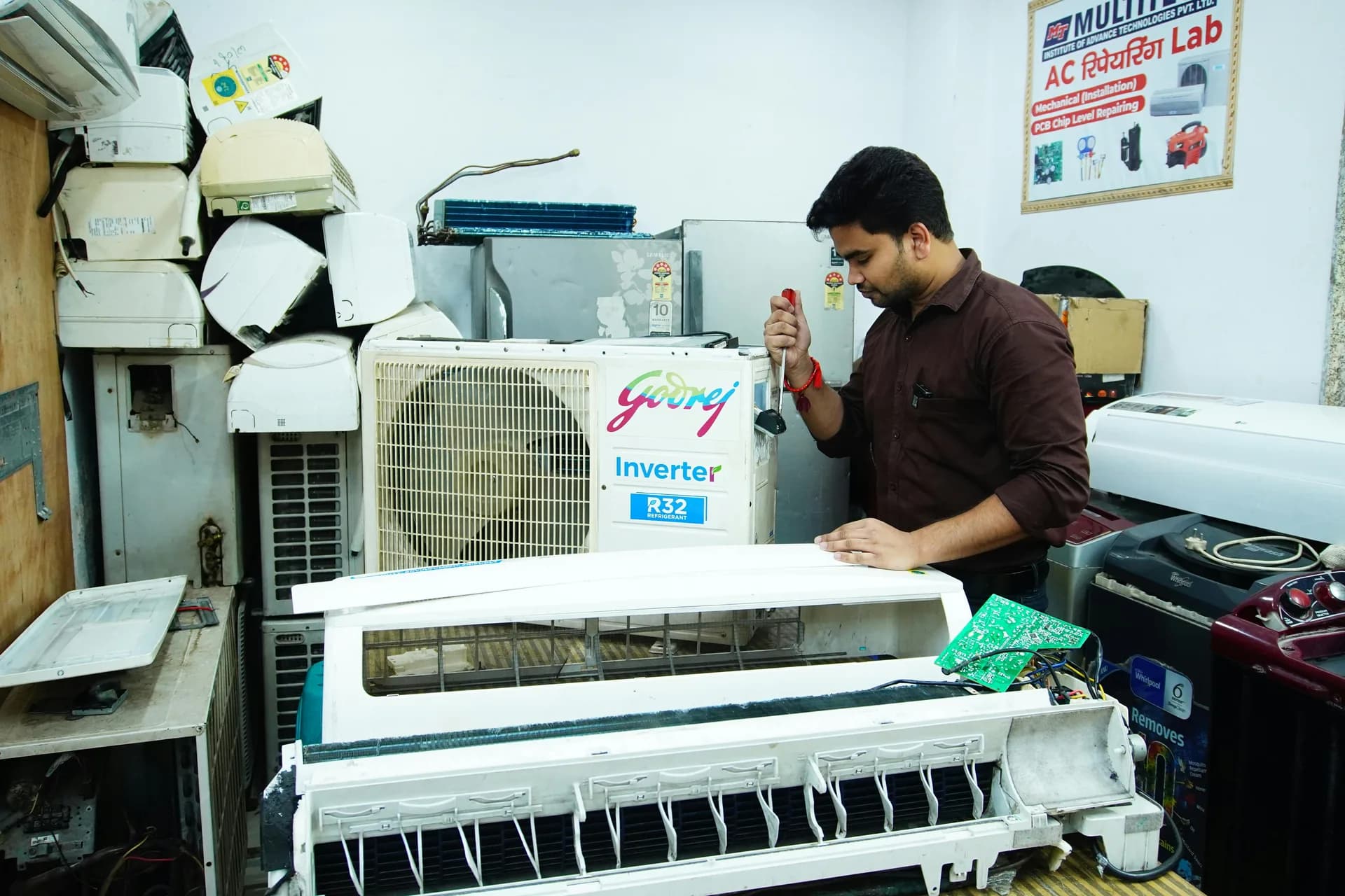Mechanic servicing a car air conditioning system