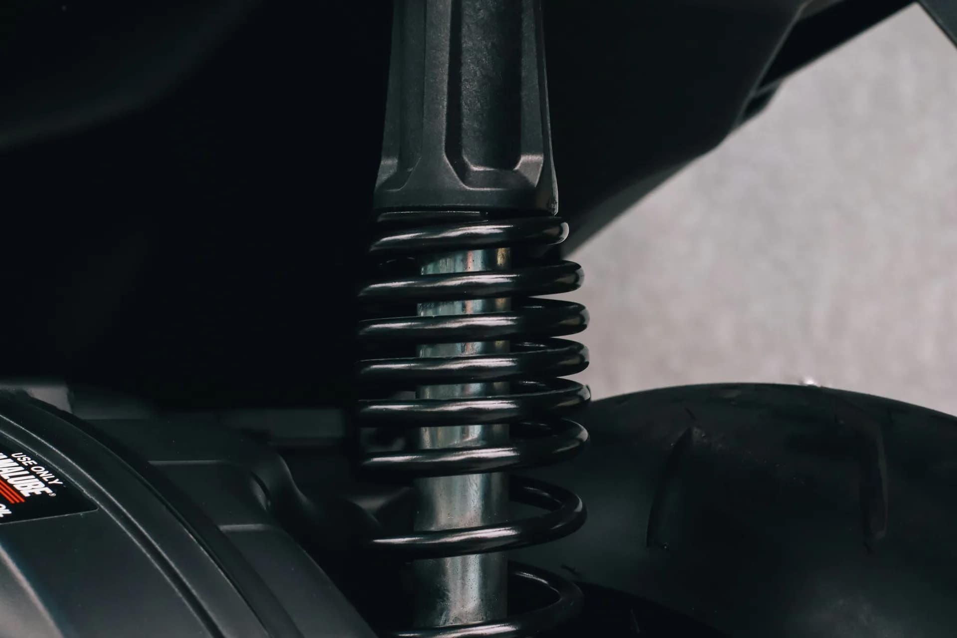 Close-up of a car shock absorber and coil spring suspension