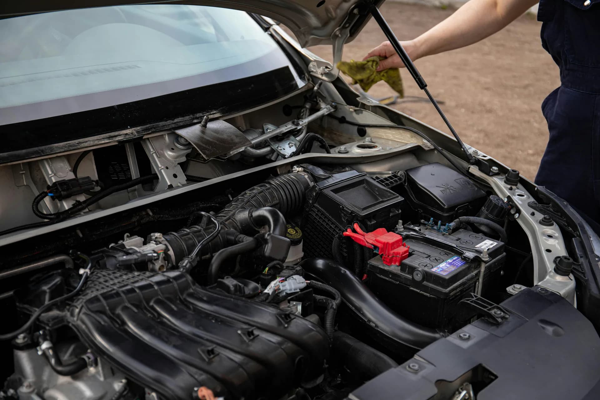 Mechanic inspecting a car engine bay during a vehicle health check